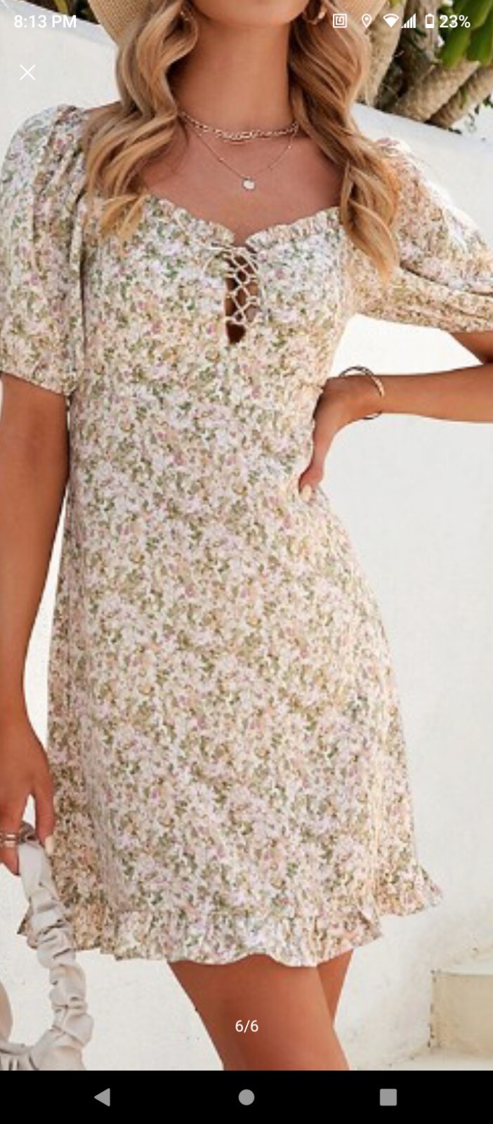 Cute, fun and feminine. Beige and green floral pattern. Short sleeves.