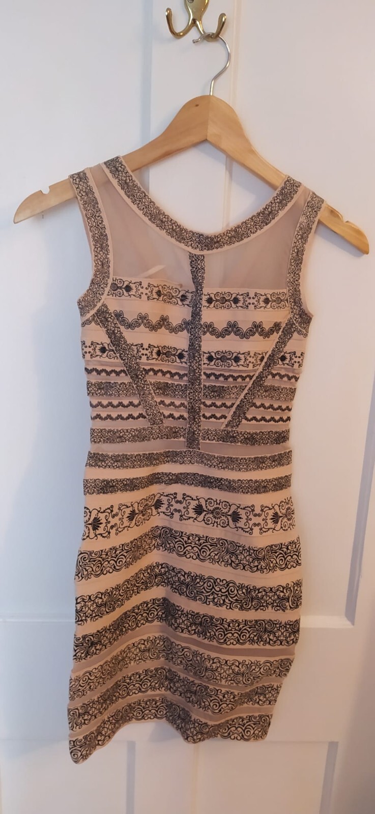 A beige and black medium dress. Layers Paris Boutique. Dry clean only. 90% Rayon